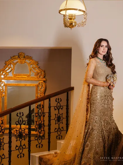 A portrait of poise. The ornate mirror and classic banister of the Taj Mahal Palace add to the regal narrative of this bridal shot. I styled her pose to feel elegant and statuesque in her shimmering golden gown.