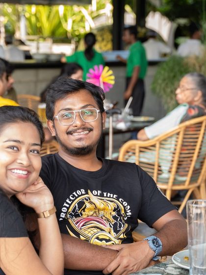 A happy couple posing for a photo, enjoying the lively atmosphere.