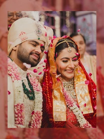 A candid shot of the couple showered in petals after their wedding ceremony. This is the look of pure happiness that makes all the planning worthwhile.