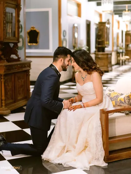 A classic romantic gesture. He gets down on one knee, not with a ring, but with a look of pure adoration. A sweet, tender moment captured on the checkered floors of the Mayfair hotel.