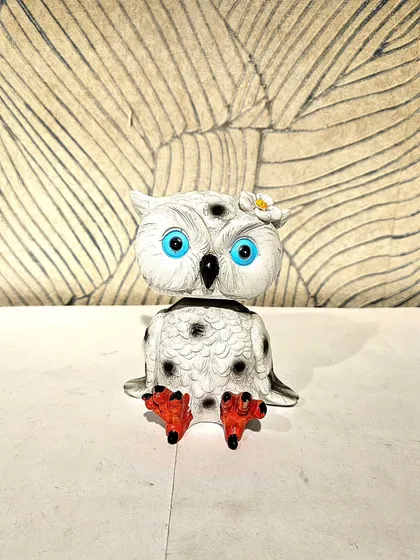 A cute bobble-head style owl showpiece in white and black.