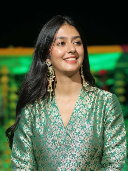 Styling for the bridal party is just as important. Vanshika chose these exquisite long earrings from the Suneet Varma collection for her brother's wedding, a perfect match for her green brocade outfit.