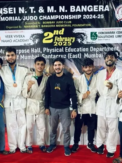 The team that grinds together, wins together. Our coach stands proudly with our team of Judokas, all displaying the medals they won through skill and determination at the championship.