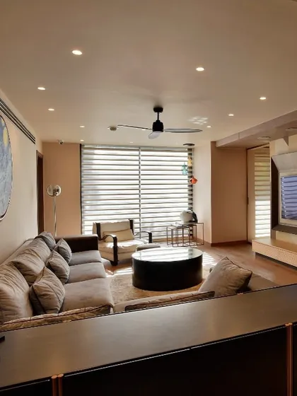 The family media room, designed as a comfortable and intimate space. A large, plush sofa faces a custom entertainment unit, creating the perfect spot for relaxation and shared moments.