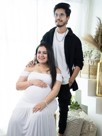 A modern and stylish couple's portrait. Dressed in coordinating white and black, this couple poses in our bright studio for a fresh and contemporary look.