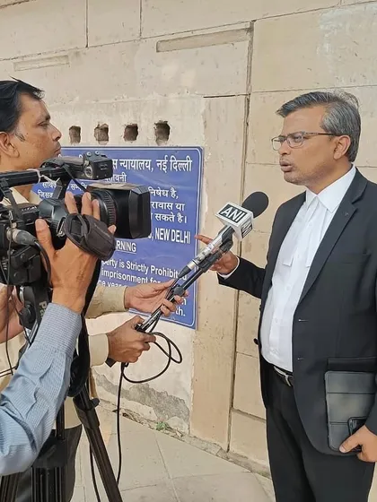 Giving an interview to an ANI reporter outside a New Delhi court, providing an update on a bail hearing.