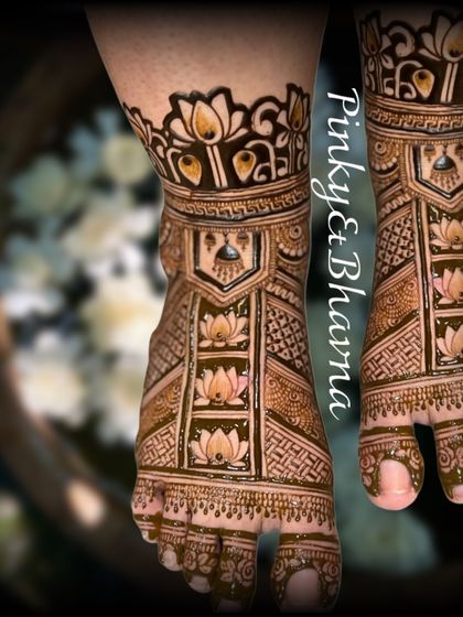 Bridal beauty extends to the feet. This intricate foot mehndi design features lotus motifs and geometric patterns, perfectly complementing the hand designs.