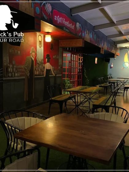 Another look at our rooftop seating area, ready for guests. The combination of green turf, rustic tables, and city skyline makes it a favorite spot.