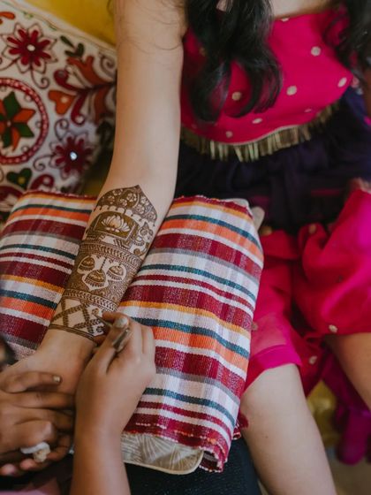 Here you can see the process of creating a traditional armband, featuring a kalash and intricate filler patterns. Each element is drawn with a steady hand.
