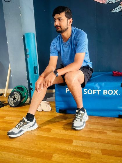 Taking a well-deserved rest between sets. Our gym provides various functional tools like plyo soft boxes for a complete workout experience.