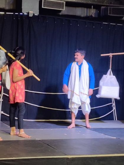 A scene depicting a village story, with students using simple props and costumes to create a vivid world. This shows their ability to work together to tell a compelling story.
