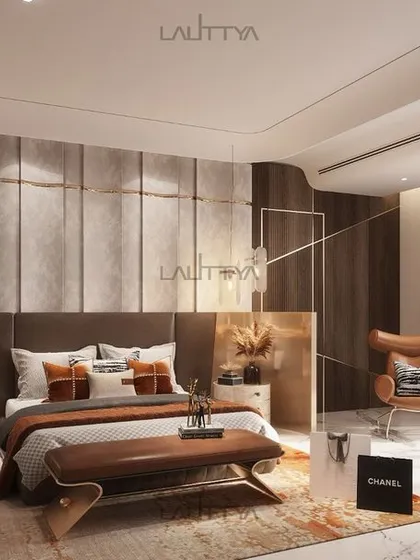 We designed this elegant bedroom with neutral tones and rich textures. A contemporary upholstered bed, a chic bench, and a bold leather chair are accented with gold and warm hues for a sophisticated feel.