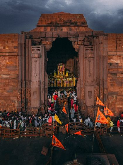 Devotees with saffron flags throng the entrance of the Bhojpur Shiva Temple, a powerful display of faith at this historic site.