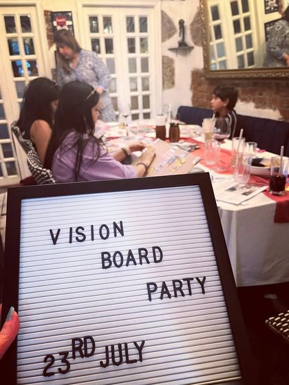 A candid shot from our first ever Vision Board Party in 2023. You can see participants of all ages getting involved, proving that manifestation and goal-setting is a timeless practice for everyone.