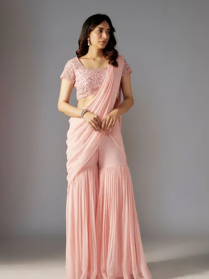 A soft pink sharara-saree, a modern and feminine silhouette that is both comfortable and stylish.