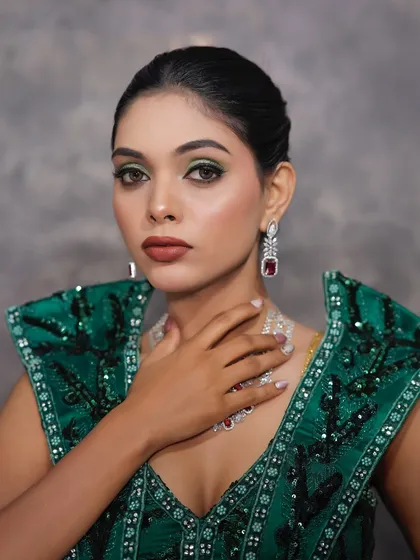 This pose highlights the stunning diamond and ruby necklace, which the makeup was designed to complement.