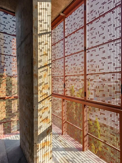 Light is a material we sculpt. In the J-House, these operable metal screens, a modern interpretation of the traditional *jaali*, modulate sunlight to create dynamic patterns, filling the space with a serene, diffused glow while ensuring privacy.