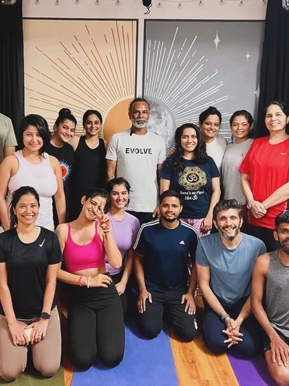 A happy group photo of our community after a rejuvenating yoga session. The smiles and positive energy reflect the supportive and light-filled space we cultivate together.