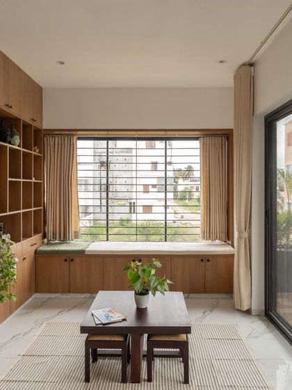 The living area in this compact home is designed for comfort and utility, with built-in storage and a large window that fills the space with natural light.
