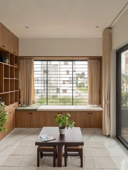 The living area in this compact home is designed for comfort and utility, with built-in storage and a large window that fills the space with natural light.