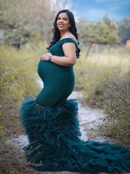 Standing strong and glowing with love in an outdoor setting. This portrait in a deep green ruffled gown shows that elegance can be found anywhere, from the studio to nature.