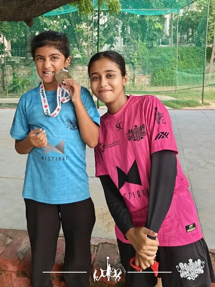 Developing multi-sport athletes. Anvi, from our program, proudly displays her medal after competing in the Ironkid Aquathlon, showcasing her swimming and running skills.