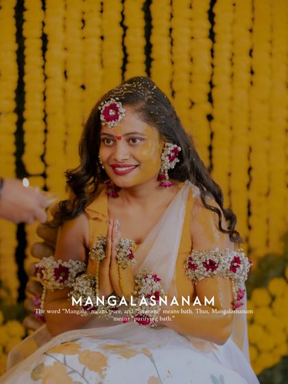 A portrait of a bride during her Mangalasnanam, capturing her happy expression as the holy water is poured.
