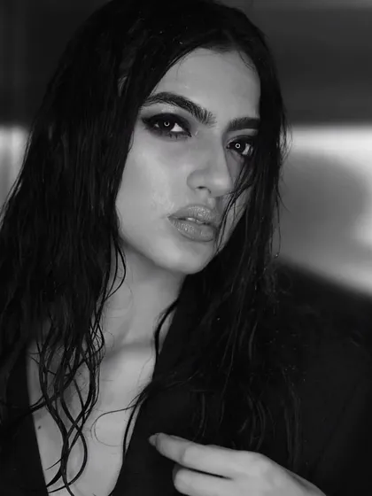 A powerful black and white portrait of Kashika Kapoor. The intense, kohl-rimmed smokey eye and wet, slicked-back hair create a dramatic and captivating look that is both timeless and modern.