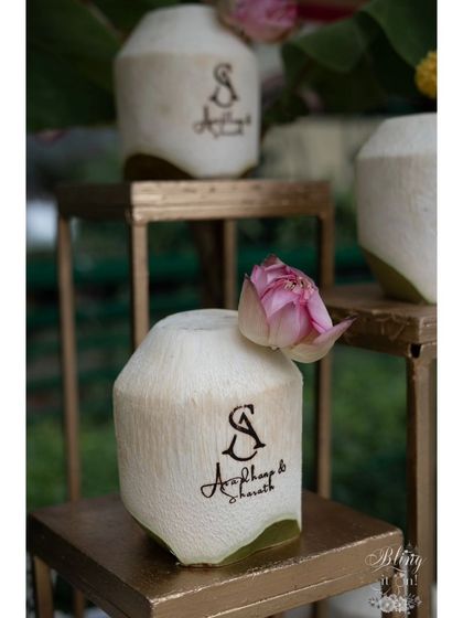 A close-up of the custom-engraved coconuts, each adorned with a delicate lotus bud. This small touch elevated a simple welcome drink into a beautiful decor element.