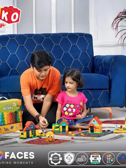A lifestyle product shoot for a children's toy brand, showing two kids actively playing with the building blocks. This type of shot is essential for demonstrating the product in use and creating an emotional connection with parents.