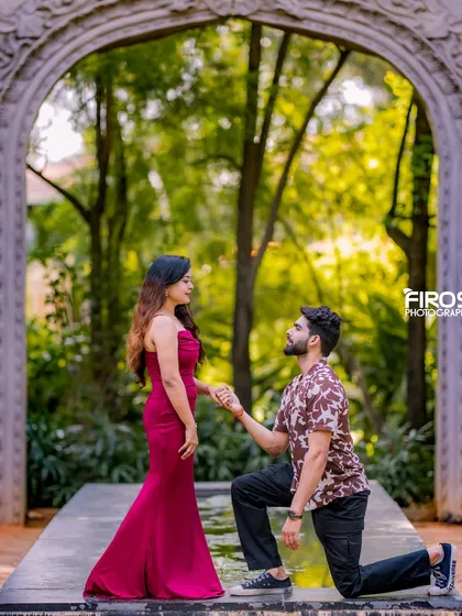 A classic proposal shot in front of a stone archway, surrounded by the lush greenery of our gardens.