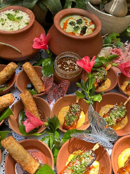 A close-up of our Asian-themed platter, showing the beautiful details of the food and the floral and butterfly garnishes that make our presentation unique.