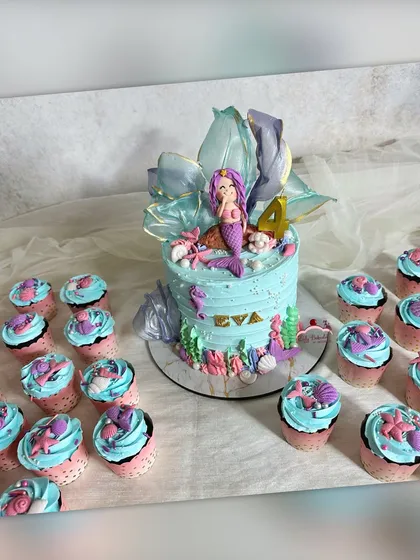 For this mermaid-themed party, I created a complete underwater world. The main cake features a custom mermaid figure and delicate sugar work, surrounded by matching chocolate mint cupcakes topped with little shells and starfish.