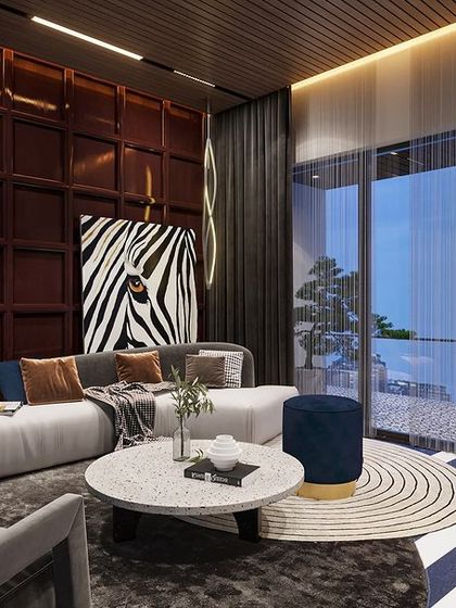 This dark-toned living area exudes confidence with its rich textures and striking zebra-print accents. The deep, moody palette and contemporary furniture make a bold statement.