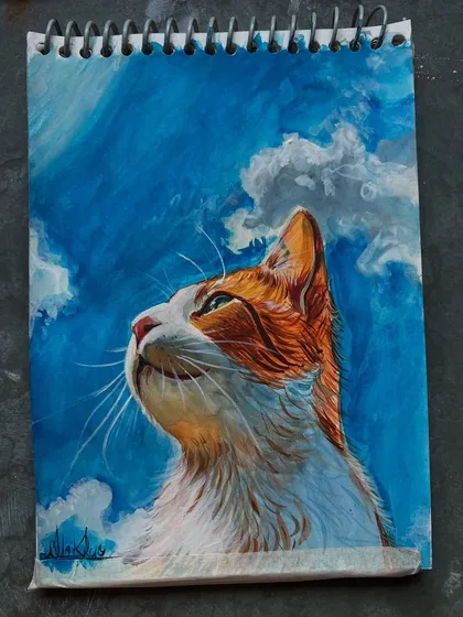 Another view of the finished cat painting, showing the vibrant blue sky and the cat's soft fur.