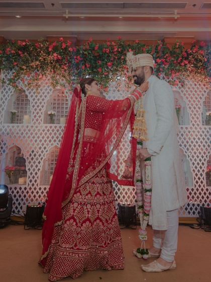 The bride's turn! A full view of the Varmala stage, showcasing the intricate decor and the happy couple.