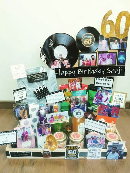 For a 60th birthday, I designed this retro-themed hamper filled with nostalgia. It features vinyl record cutouts, old photos, and treats that take them on a trip down memory lane, celebrating a life full of memories.