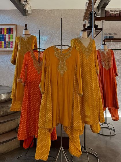 Another angle of the beautiful orange and yellow outfits, highlighting their relaxed fit and festive feel.