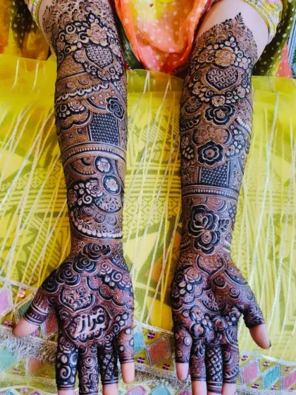 A stunning bridal design with full coverage, featuring the name 'Faraz' on the palm. The rich color and detail are perfect for a bride.