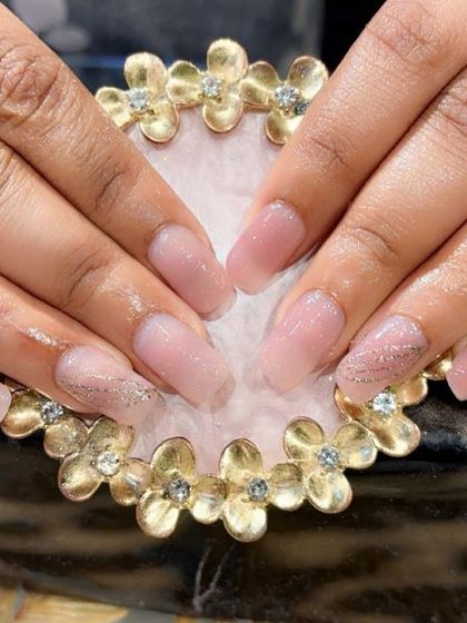 A beautiful result on natural nails. This client has a sheer pink gel overlay with a subtle touch of glitter for strength and style.