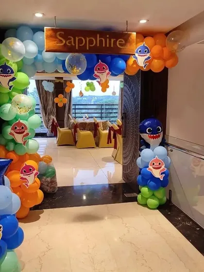 A Baby Shark themed party entrance with colorful balloon arches welcoming guests.
