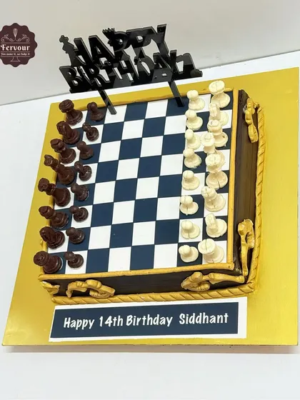 A top-down view of the chess theme cake, highlighting the perfectly crafted board and the arrangement of the dark and white chocolate chess pieces.