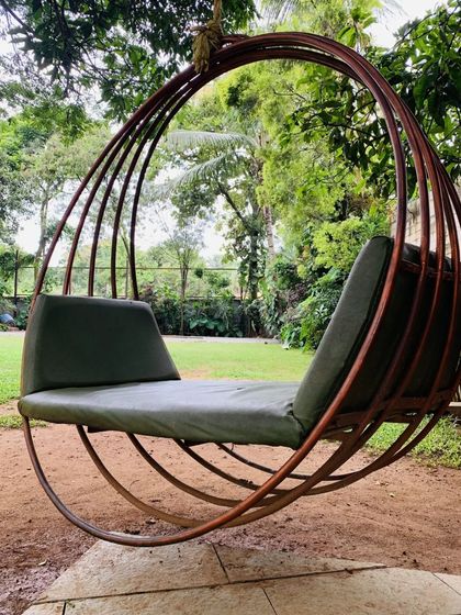 One of our comfortable swing chairs, nestled in a quiet green corner of the resort. It's an ideal spot for reading a book or simply enjoying a moment of peace.