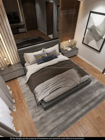An overhead view of a master bedroom, featuring a wood-paneled accent wall, a large area rug, and a sleek, modern bed frame.