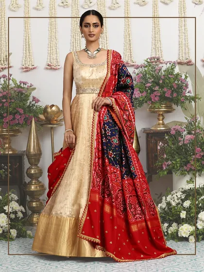 A framed shot of the gold gown and Bandhani dupatta, emphasizing its status as a work of wearable art.