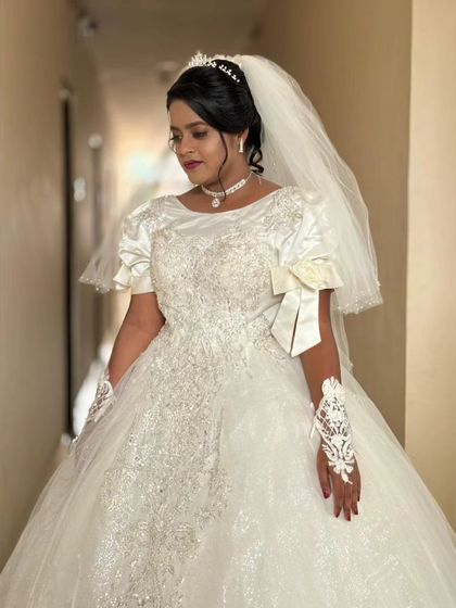 A close-up of Rachel's gown, showing the delicate embroidery on the bodice and the elegant bow detail on the sleeves. It's these small touches that make a dress unique.