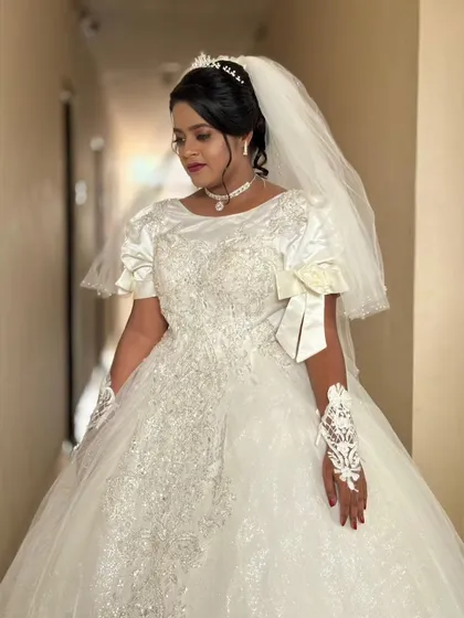 A close-up of Rachel's gown, showing the delicate embroidery on the bodice and the elegant bow detail on the sleeves. It's these small touches that make a dress unique.