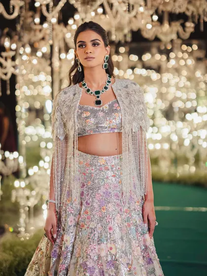 For a bride's sangeet, we wanted a showstopper. This stunning floral lehenga with a beaded cape was a look we spotted on the runway and knew it was the one. It’s all about finding that perfect balance of glamour and personality.
