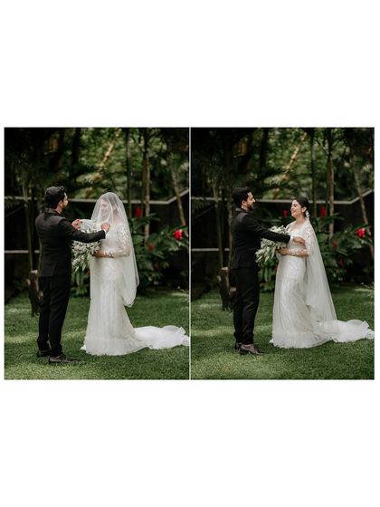 A tender moment as the groom helps his bride with her veil, a beautiful, unscripted gesture of care and love.