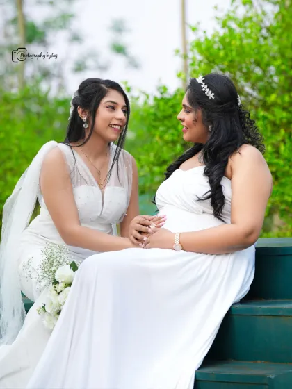 A beautiful portrait of two friends or sisters in white, seated on green steps in our garden.